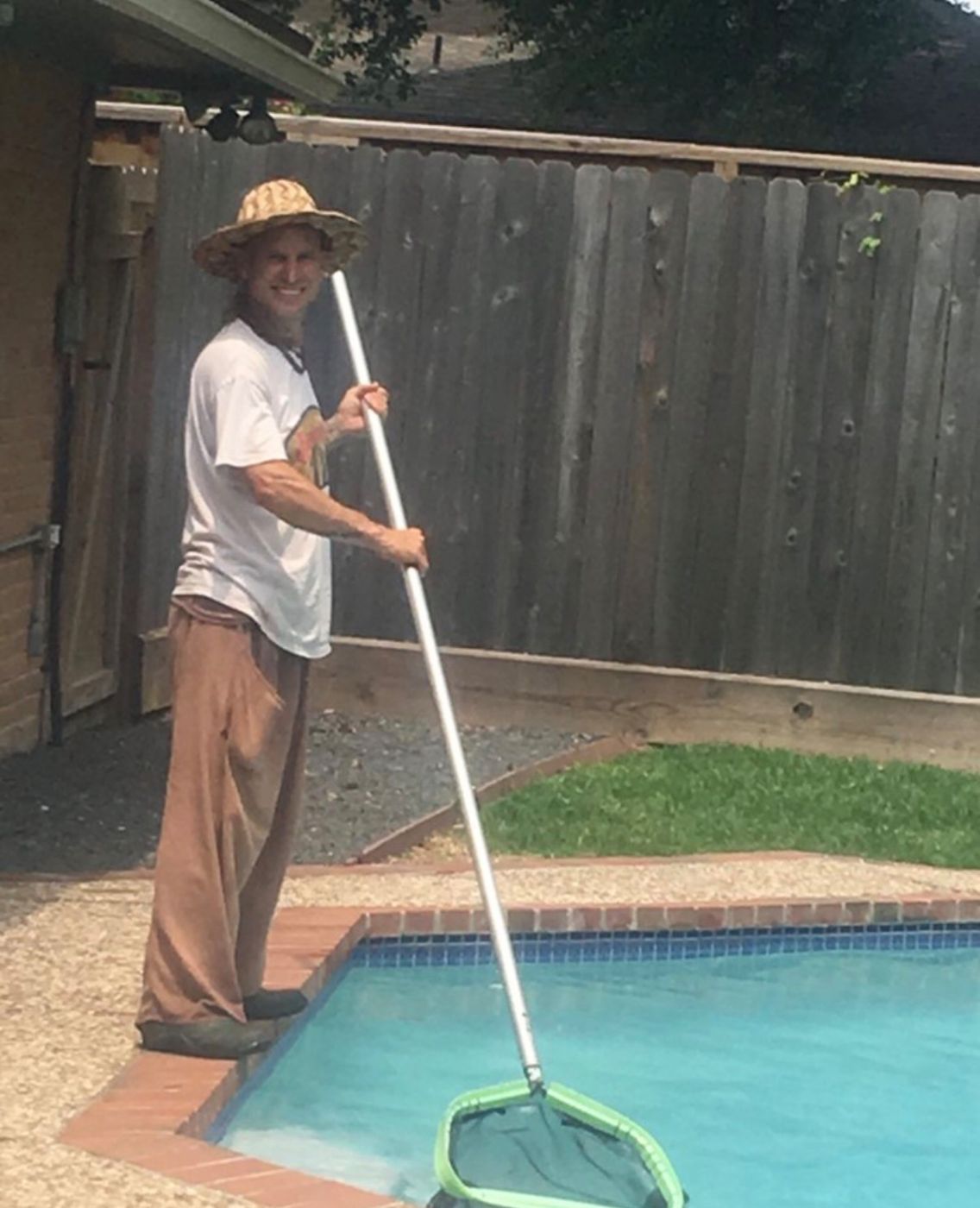 Robert skimming a customer's pool